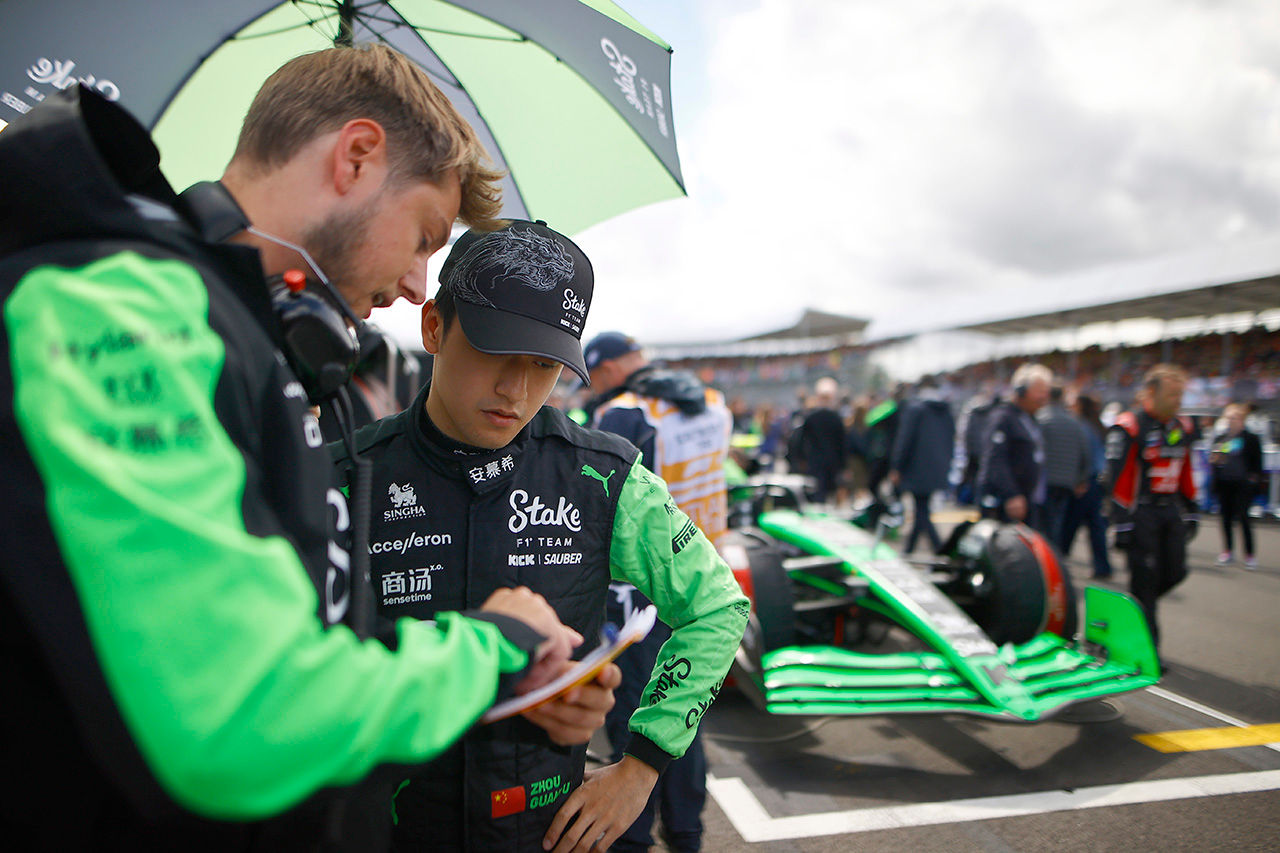Zhou Guanyu, Stake F1 Team Kick Sauber, on the grid with his engineer; 2024 British Grand Prix, Formula One World Championship