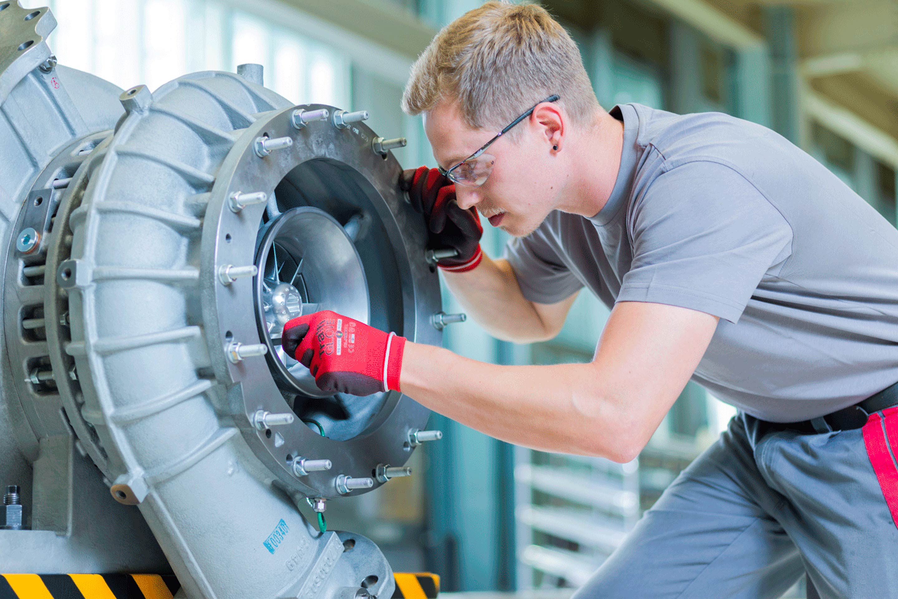 An engineer servicing an ABB turbocharger
