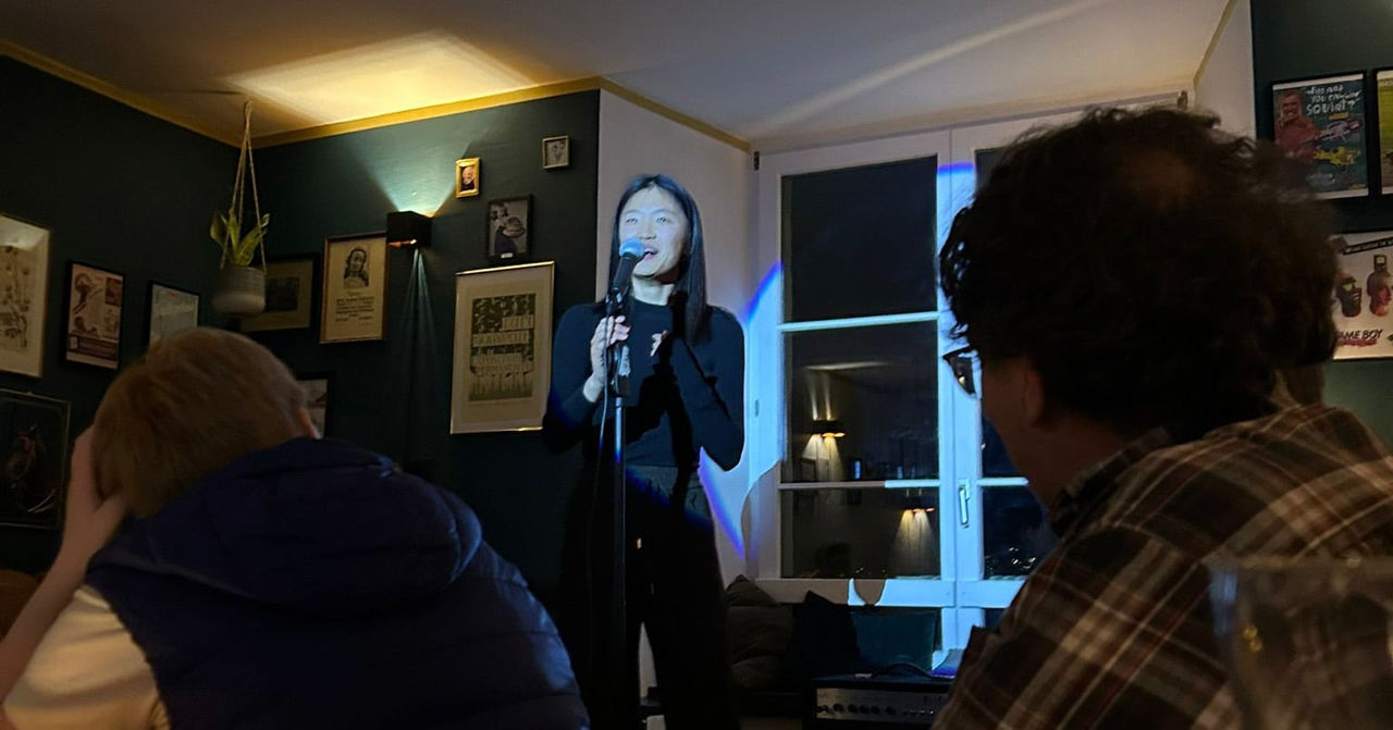 What fear? Qiyan doing stand-up comedy for the first time at a pub in Aarau, Switzerland, in 2025, with Toastmasters friends