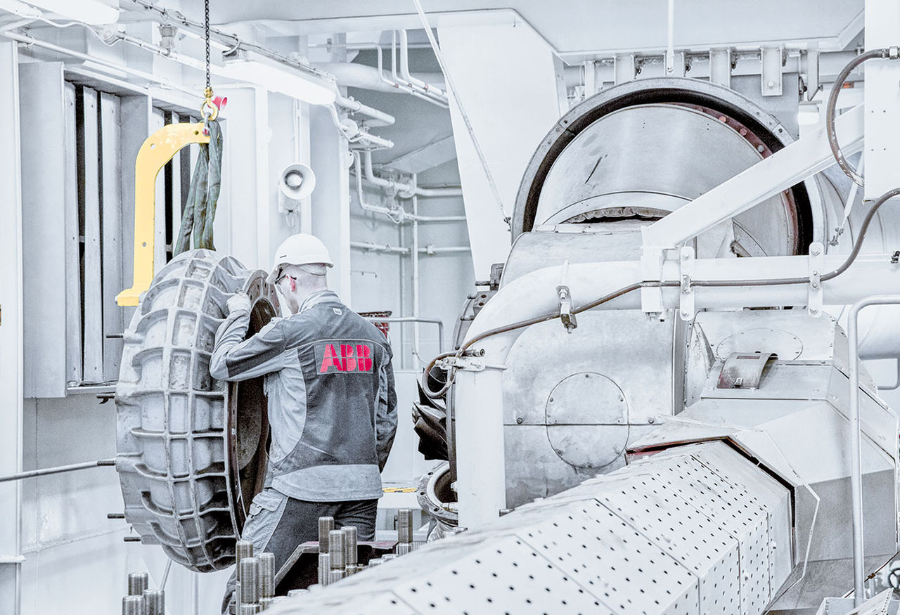 An engineer working on a ship's engine and turbocharger